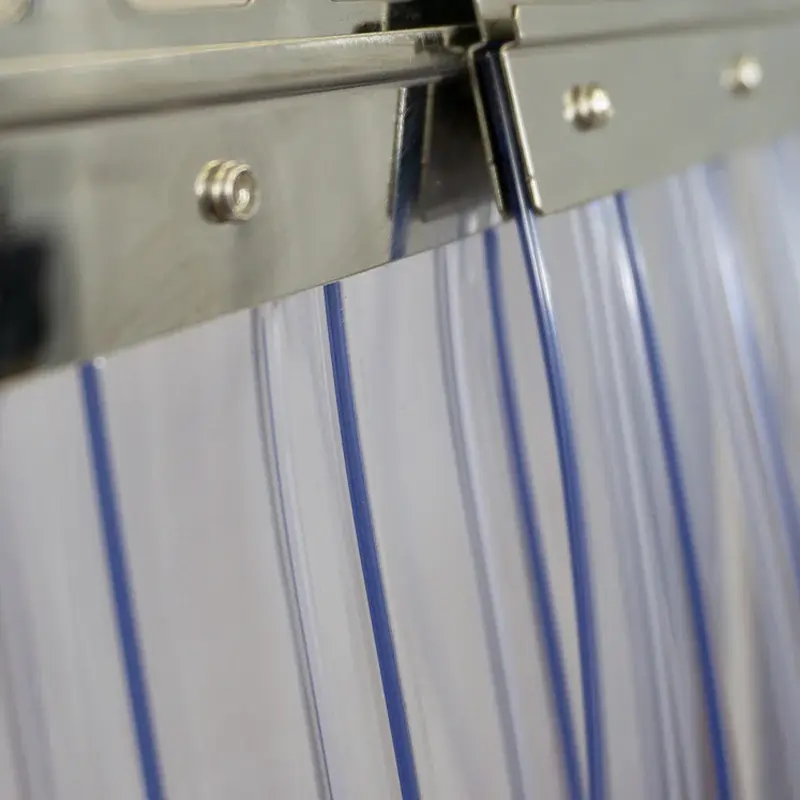 Plastic Ribbed PVC strip curtains hung on plates and rails shown up close, zoomed in on the plates